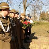 Delegacja służb mundurowych składa kwiaty pod pomnikiem